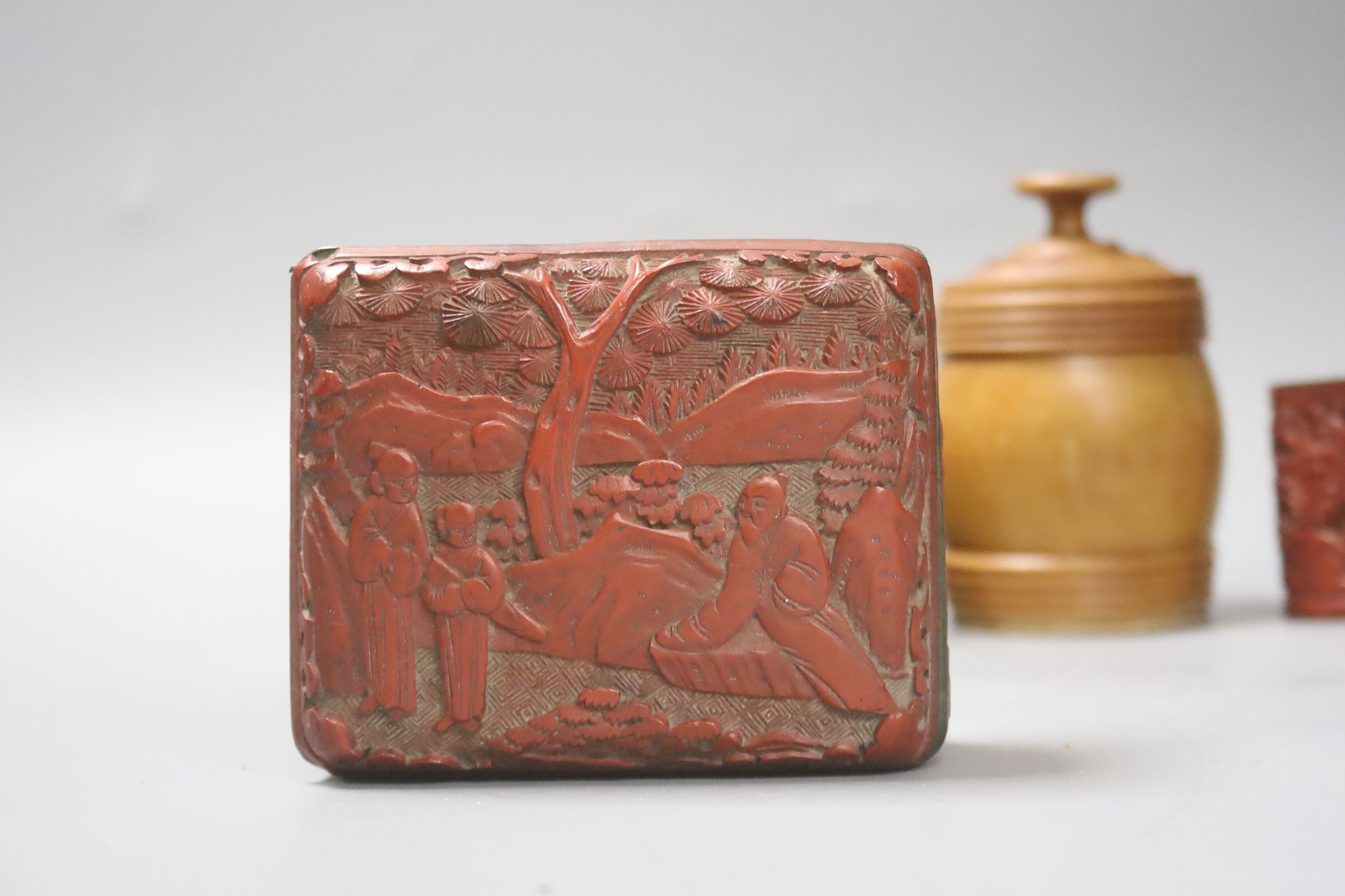 A Chinese cinnabar lacquer cigarette box and cover, 10cm and a similar match holder and a Dutch treen match holder